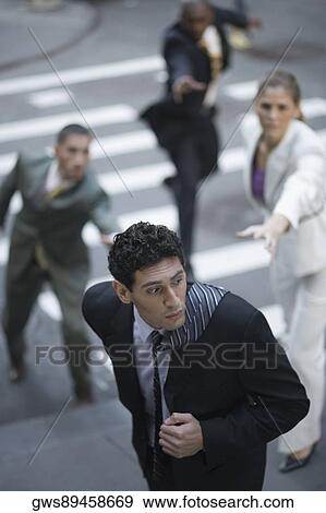 High angle view of business executives chasing a businessman View Large Photo Image Stock Photo - High angle view of business executives chasing a businessman. Fotosearch
