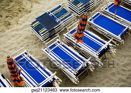 Stock Image - High angle view of folded lounge chairs, Italian Riviera, Cinque Terre, La Spezia, Liguria, Italy. Fotosearch