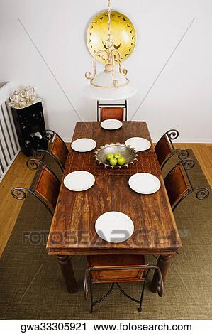 High angle view of place setting on a dining table View Large Photo Image Stock Image - High angle view of place setting on a dining table. Fotosearch