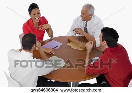 High angle view of three businessmen and a businesswoman laughing in a meeting View Large Photo Image Picture - High angle view of three businessmen and a businesswoman laughing in a meeting. Fotosearch