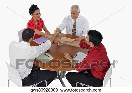 High angle view of three businessmen and a businesswoman shaking hands View Large Photo Image Stock Photo - High angle view of three businessmen and a businesswoman shaking hands. Fotosearch