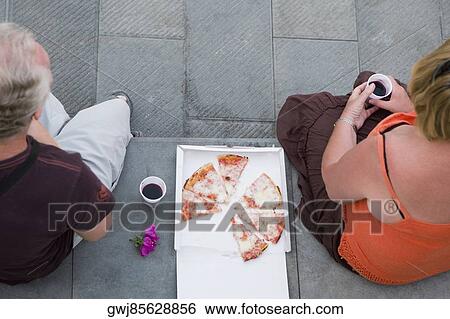 High angle view of two people having pizza, Italian Riviera, Genoa, Liguria, Italy View Large Photo Image Stock Photograph - High angle view of two people having pizza, Italian Riviera, Genoa, Liguria, Italy. Fotosearch