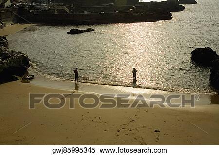 High angle view of two people standing on the beach, Port Des Pecheurs, Biarritz, France View Large Photo Image Stock Photography - High angle view of two people standing on the beach, Port Des Pecheurs, Biarritz, France. Fotosearch