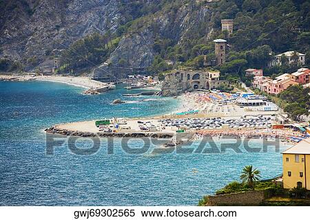 Stock Photography - Houses in a town at the seaside, Ligurian Sea, Italian Riviera, Cinque Terre, La Spezia, Liguria, Italy. Fotosearch