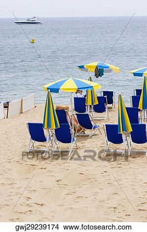 Lounge chairs and beach umbrellas on the beach, Plage De La Croisette, Cote d'Azur, Cannes, Provence-Alpes-Cote D'Azur, France View Large Photo Image Picture - Lounge chairs and beach umbrellas on the beach, Plage De La Croisette, Cote d'Azur, Cannes, Provence-Alpes-Cote D'Azur, France. Fotosearch