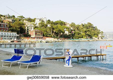 Lounge chairs on the beach, Italian Riviera, Santa Margherita Ligure, Genoa, Liguria, Italy View Large Photo Image Stock Photo - Lounge chairs on the beach, Italian Riviera, Santa Margherita Ligure, Genoa, Liguria, Italy. Fotosearch