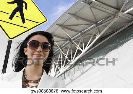 Low angle view of a businesswoman smiling at an airport View Large Photo Image Stock Photo - Low angle view of a businesswoman smiling at an airport. Fotosearch