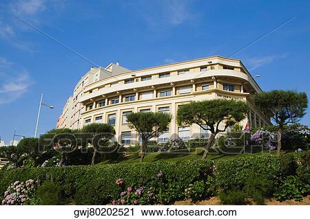 Stock Image - Low angle view of a formal garden in front of a building, Biarritz, Pyrenees-Atlantiques, Aquitaine, France. Fotosearch