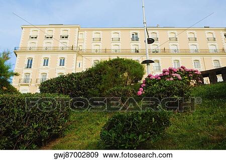 Stock Photo - Low angle view of a formal garden in front of a building, Biarritz, Basque Country, Pyrenees-Atlantiques, Aquitaine, France. Fotosearch