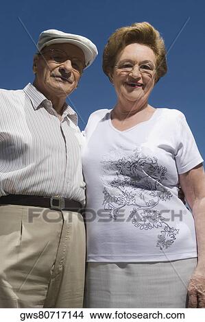 Low angle view of a senior couple smiling View Large Photo Image Picture - Low angle view of a senior couple smiling. Fotosearch