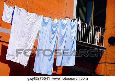 Stock Image - Low angle view of clothes hanging on a clothesline, Naples, Naples Province, Campania, Italy. Fotosearch