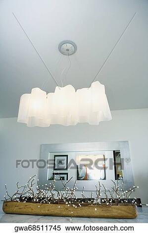 Stock Photography - Low angle view of lamp shades over a dining table. Fotosearch
