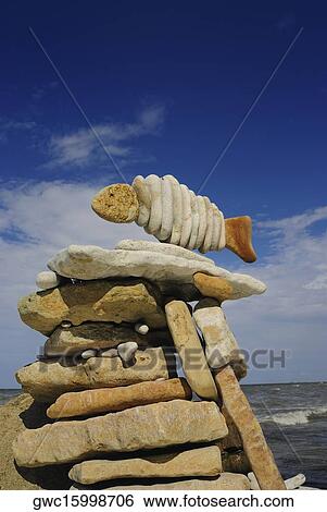 Low angle view of pebbles arranged in a fish shape View Large Photo Image Stock Photograph - Low angle view of pebbles arranged in a fish shape. Fotosearch