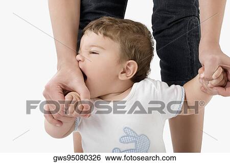 Low section view of a woman holding her baby's hands View Large Photo Image Stock Photograph - Low section view of a woman holding her baby's hands. Fotosearch