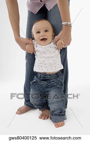 Low section view of a woman walking with her baby boy View Large Photo Image Stock Photography - Low section view of a woman walking with her baby boy. Fotosearch
