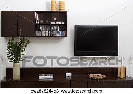 Magazines and a vase on a coffee table in front of a television set View Large Photo Image Stock Image - Magazines and a vase on a coffee table in front of a television set. Fotosearch