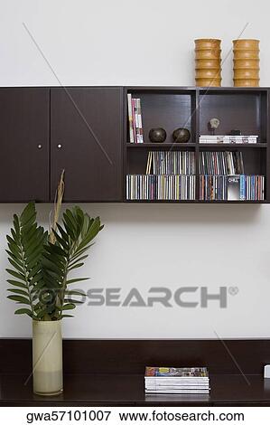 Magazines and a vase on a coffee table View Large Photo Image Stock Photo - Magazines and a vase on a coffee table. Fotosearch