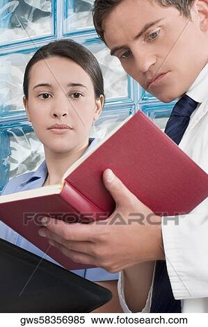 Male and a female doctor discussing a medical record View Large Photo Image Stock Photography - Male and a female doctor discussing a medical record. Fotosearch