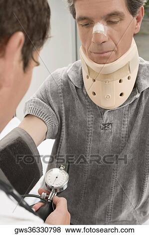 Male doctor checking blood pressure of a mature man View Large Photo Image Stock Photo - Male doctor checking blood pressure of a mature man. Fotosearch