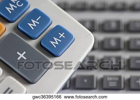 Stock Photograph - Mathematical symbols on a calculator and a computer keyboard in the background. Fotosearch