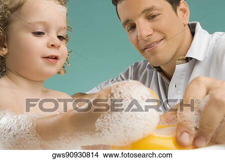 Mid adult man playing with his daughter View Large Photo Image Picture - Mid adult man playing with his daughter. Fotosearch