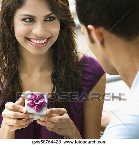 Mid adult man proposing to a young woman View Large Photo Image Stock Photo - Mid adult man proposing to a young woman. Fotosearch