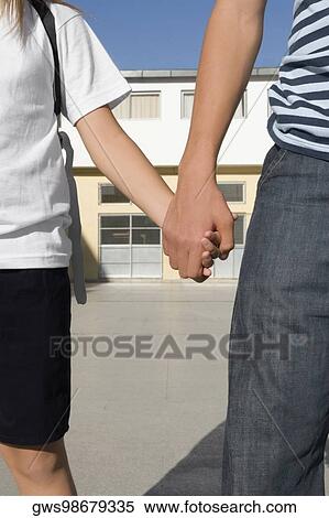 Mid section view of a boy holding hand of his sister View Large Photo Image Stock Photography - Mid section view of a boy holding hand of his sister. Fotosearch