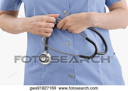 Stock Photo - Mid section view of a doctor holding a stethoscope. Fotosearch