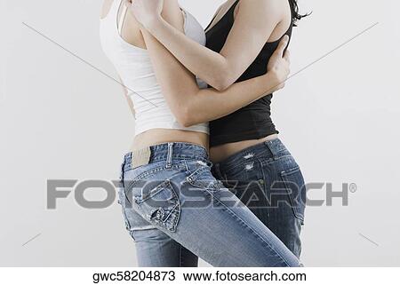 Mid section view of a female homosexual couple embracing each other View Large Photo Image Stock Image - Mid section view of a female homosexual couple embracing each other. Fotosearch