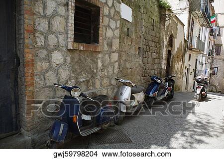 Motor scooters parked in front of buildings, Sorrento, Sorrentine Peninsula, Naples Province, Campania, Italy View Large Photo Image Picture - Motor scooters parked in front of buildings, Sorrento, Sorrentine Peninsula, Naples Province, Campania, Italy. Fotosearch
