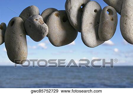 Pebbles in air with sea in the background View Large Photo Image Stock Photo - Pebbles in air with sea in the background. Fotosearch