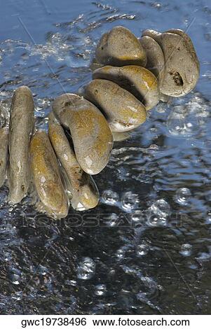 Pebbles in water View Large Photo Image Stock Photograph - Pebbles in water. Fotosearch