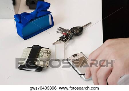 Stock Photograph - Person's hand on a mobile phone. Fotosearch