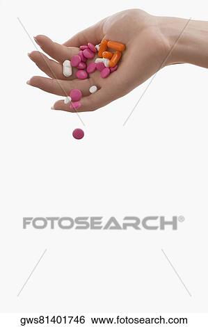 Pills falling from a person's hand View Large Photo Image Stock Photograph - Pills falling from a person's hand. Fotosearch