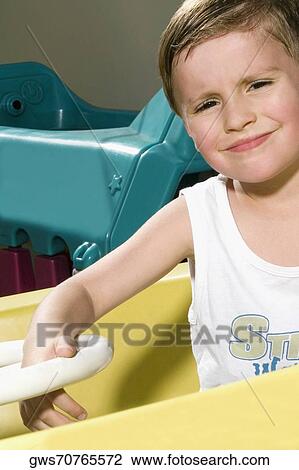 Portrait of a boy in a toy car View Large Photo Image Stock Image - Portrait of a boy in a toy car. Fotosearch