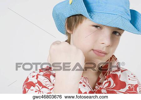 Portrait of a boy wearing a hat and looking confident View Large Photo Image Stock Photograph - Portrait of a boy wearing a hat and looking confident. Fotosearch