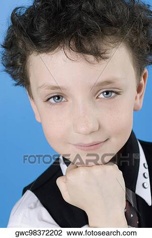 Portrait of a boy with his hand on his chin View Large Photo Image Stock Image - Portrait of a boy with his hand on his chin. Fotosearch