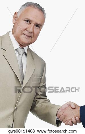 Stock Photo - Portrait of a businessman shaking hands with another businessman. Fotosearch