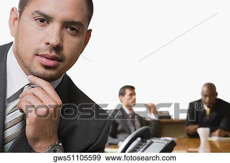 Portrait of a businessman smiling with other business executives in a board room View Large Photo Image Stock Photo - Portrait of a businessman smiling with other business executives in a board room. Fotosearch