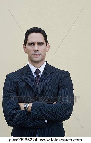 Portrait of a businessman standing with his arms crossed View Large Photo Image Picture - Portrait of a businessman standing with his arms crossed. Fotosearch