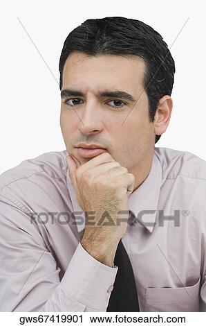 Stock Image - Portrait of a businessman thinking with his hand on his chin. Fotosearch