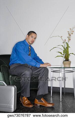 Portrait of a businessman using a laptop View Large Photo Image Stock Photo - Portrait of a businessman using a laptop. Fotosearch