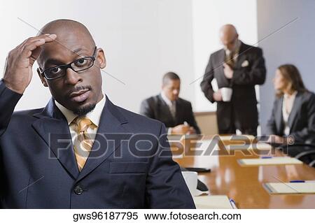 Portrait of a businessman with other business executives in a board room View Large Photo Image Stock Photography - Portrait of a businessman with other business executives in a board room. Fotosearch
