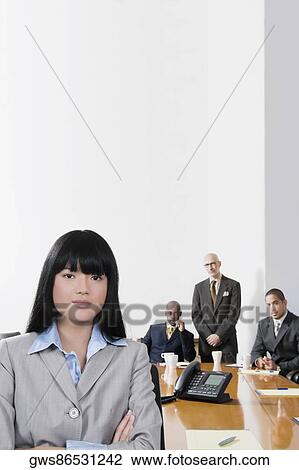 Portrait of a businesswoman smiling with other business executives in a board room View Large Photo Image Stock Image - Portrait of a businesswoman smiling with other business executives in a board room. Fotosearch