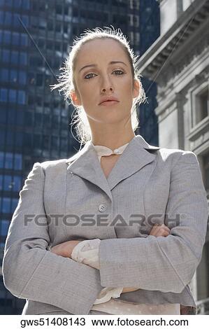 Portrait of a businesswoman standing with her arms crossed View Large Photo Image Stock Image - Portrait of a businesswoman standing with her arms crossed. Fotosearch