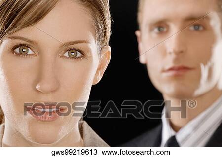 Portrait of a businesswoman with a businessman behind her View Large Photo Image Stock Image - Portrait of a businesswoman with a businessman behind her. Fotosearch