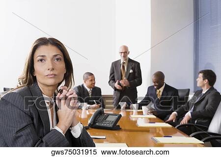 Portrait of a businesswoman with other business executives in a board room View Large Photo Image Stock Photography - Portrait of a businesswoman with other business executives in a board room. Fotosearch