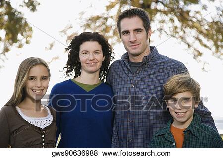 Stock Photo - Portrait of a couple with their two children. Fotosearch