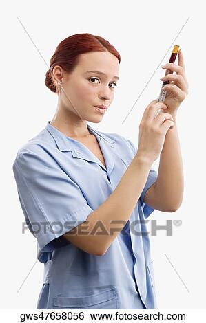 Portrait of a female doctor filling a syringe from a vial View Large Photo Image Stock Photograph - Portrait of a female doctor filling a syringe from a vial. Fotosearch