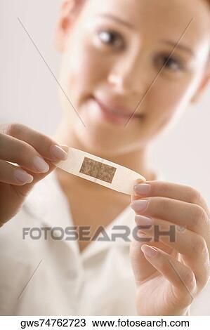 Portrait of a female doctor holding a bandage View Large Photo Image Stock Image - Portrait of a female doctor holding a bandage. Fotosearch